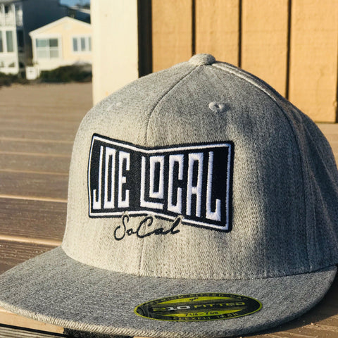 Gray flat bill cotton cap. Black and white embroidered Joe Local So Cal flag logo. Flex fit, premium fitted cap
