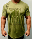 60% Cotton, 40% Poly. Military green Crew neck. shirt has a large screen print in greenish brown. logo is of a warrior helmet layered over and American flag. phrase “Peaceful Not Passive. The word “peaceful” is located at top of the flag/helmet and the words “not passive” is featured at bottom of the flag/helmet. back of the t-shirt features small simple “Joe Local” logo across top of t-shirt under the neck. left sleeve features a small screen print of the American flag in greenish brown.