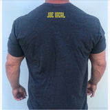 Back of T-shirt. Joe Local logo in yellow is featured at the top center of the shirt under the neck. The following is description is for the front of the shirt. Dark grey t-shirt with yellow Joe Local So Cal flag logo at the center of the chest. Well fitted and comfortable t-shirt. Fabric: CVC Jersey 60% Combed Ring-Spun Cotton 40% Polyester /32 singles, 145 grams/4.3 oz Neck: Crew